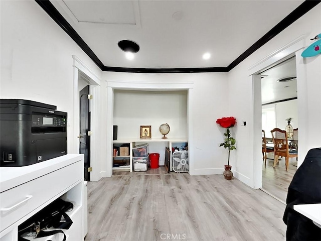 home office featuring attic access, wood finished floors, crown molding, and baseboards
