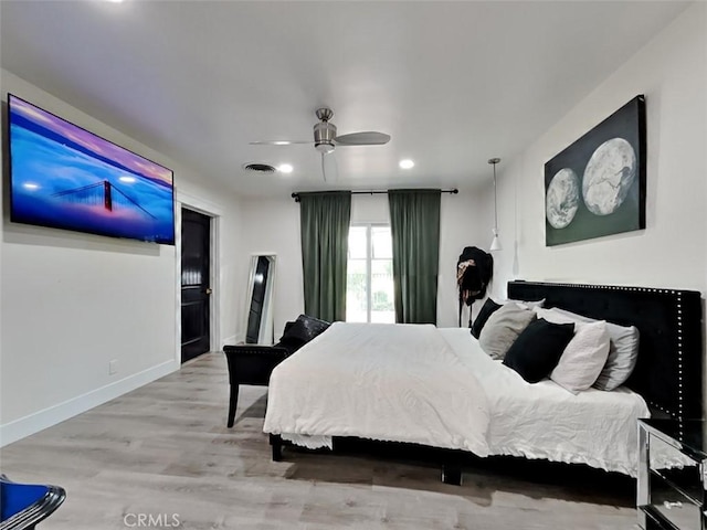 bedroom featuring a ceiling fan, wood finished floors, baseboards, visible vents, and recessed lighting