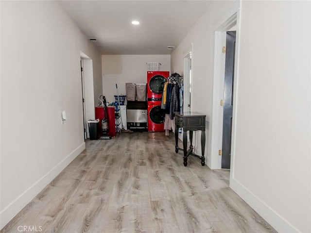 corridor featuring baseboards and wood finished floors