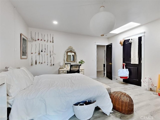 bedroom featuring wood finished floors and baseboards