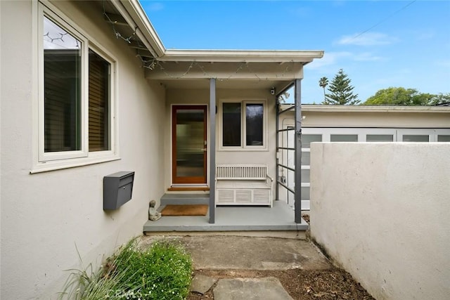 view of exterior entry featuring stucco siding