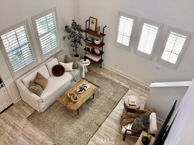 9 Adelfa St, Rancho Mission Viejo, CA 92694 - living room featuring plenty of natural light, baseboards, and wood finished floors