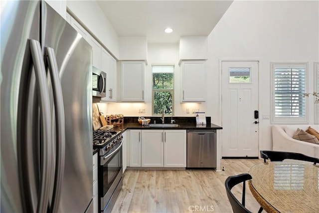 9 Adelfa St, Rancho Mission Viejo, CA 92694 - kitchen with light wood-style floors, plenty of natural light, stainless steel appliances, and a sink