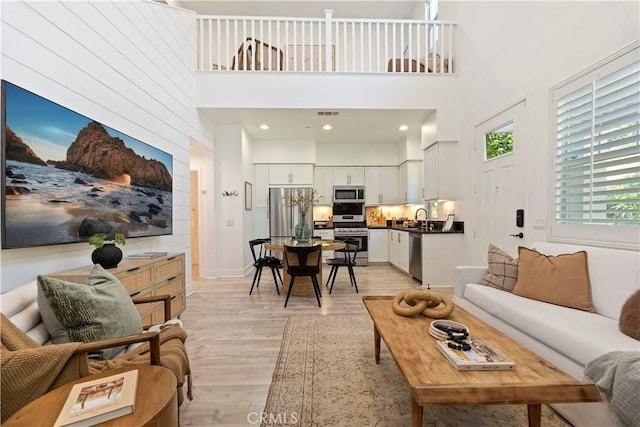 9 Adelfa St, Rancho Mission Viejo, CA 92694 - living room with light wood finished floors, a high ceiling, and visible vents
