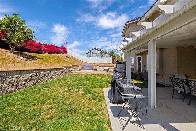 view of yard featuring fence and a patio