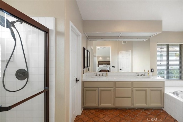 ensuite bathroom featuring connected bathroom, tile patterned floors, a sink, and tiled shower