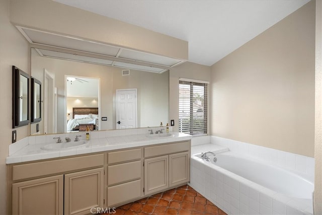 full bathroom featuring a bath, ensuite bath, a sink, and double vanity