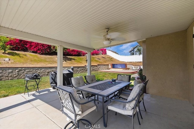 view of patio featuring outdoor dining space and a ceiling fan