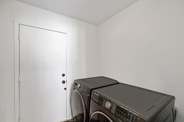 laundry room with washing machine and clothes dryer and laundry area