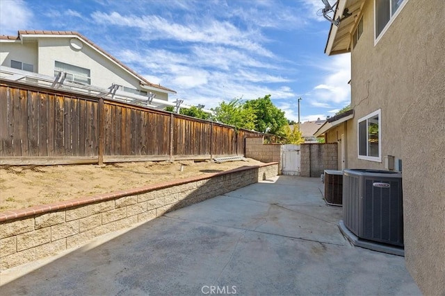 view of patio / terrace with a fenced backyard and central air condition unit