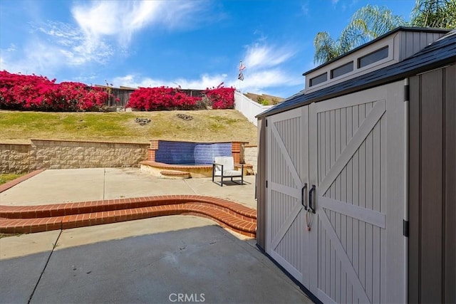view of shed featuring fence