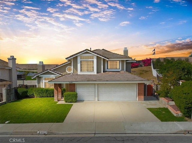 traditional home with an attached garage, brick siding, fence, and a tiled roof