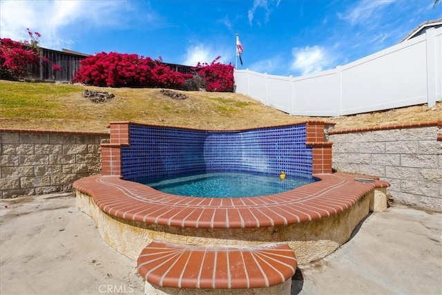 view of swimming pool with fence and a yard