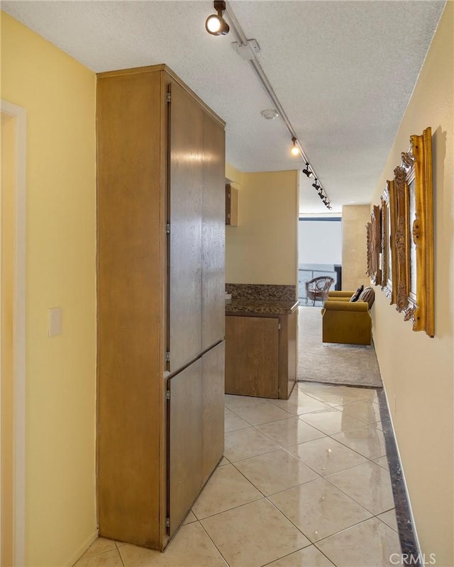 615 Esplanade Unit 302, Redondo Beach, CA 90277 - corridor featuring light tile patterned floors, rail lighting, and a textured ceiling