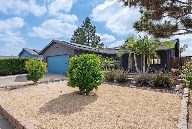 6770 Amberly St, San Diego, CA 92120 - view of front of property with an attached garage, roof mounted solar panels, stucco siding, and driveway