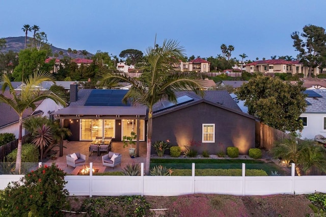 6770 Amberly St, San Diego, CA 92120 - view of front of property featuring an outdoor hangout area, a fenced backyard, solar panels, and a patio area