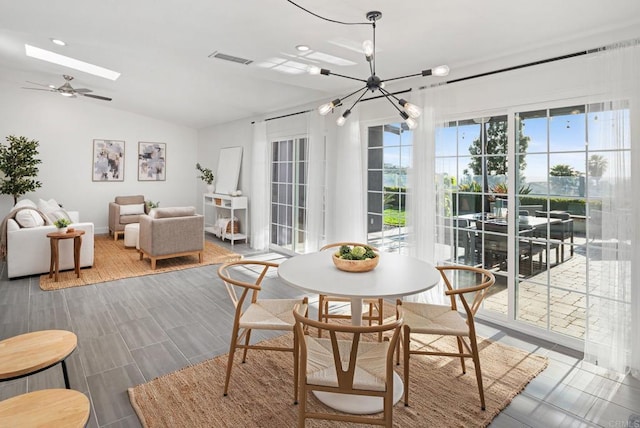 6770 Amberly St, San Diego, CA 92120 - dining room featuring vaulted ceiling, a chandelier, ceiling fan, and a skylight