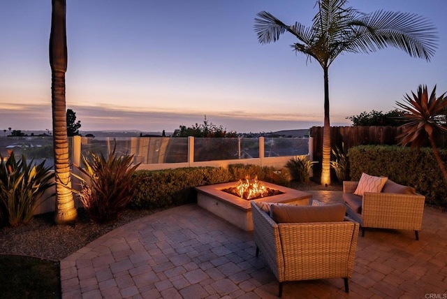 6770 Amberly St, San Diego, CA 92120 - patio terrace at dusk with an outdoor fire pit and a patio