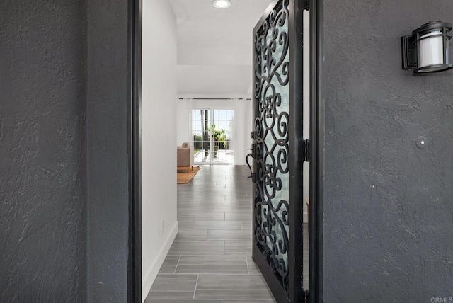 6770 Amberly St, San Diego, CA 92120 - hallway featuring a textured wall and baseboards