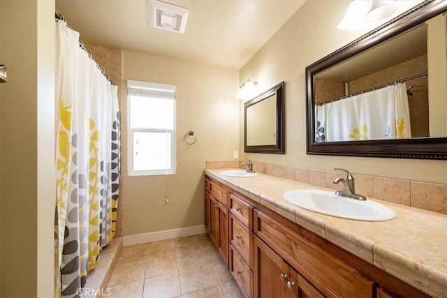 2103 Price St, San Luis Obispo, CA 93401 - bathroom featuring visible vents, tile patterned floors, baseboards, and a sink