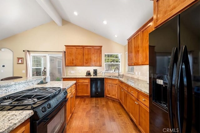2103 Price St, San Luis Obispo, CA 93401 - kitchen with a sink, brown cabinetry, black appliances, beamed ceiling, and wood-type flooring