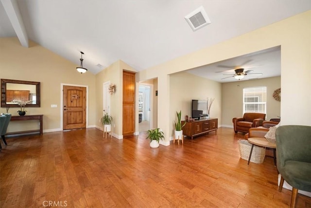 2103 Price St, San Luis Obispo, CA 93401 - living area with wood finished floors, visible vents, vaulted ceiling with beams, and a ceiling fan