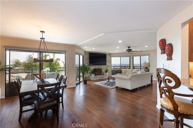 2270 Stanley Ave Unit 2B, Signal Hill, CA 90755 - dining space with dark wood finished floors, a stone fireplace, a ceiling fan, healthy amount of natural light, and recessed lighting