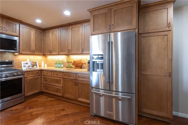 2270 Stanley Ave Unit 2B, Signal Hill, CA 90755 - kitchen featuring stainless steel appliances, dark wood-style floors, decorative backsplash, recessed lighting, and light stone counters