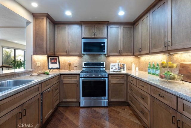 2270 Stanley Ave Unit 2B, Signal Hill, CA 90755 - kitchen with stainless steel appliances, dark wood finished floors, light stone counters, a sink, and backsplash