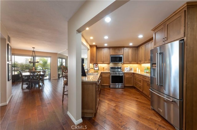 2270 Stanley Ave Unit 2B, Signal Hill, CA 90755 - kitchen with appliances with stainless steel finishes, a sink, dark wood-type flooring, baseboards, and decorative backsplash
