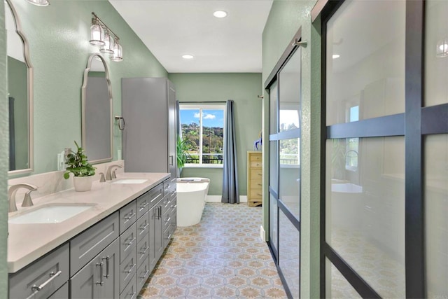 4710 Sleeping Indian Rd, Fallbrook, CA 92028 - bathroom featuring recessed lighting, double vanity, a freestanding tub, and a sink