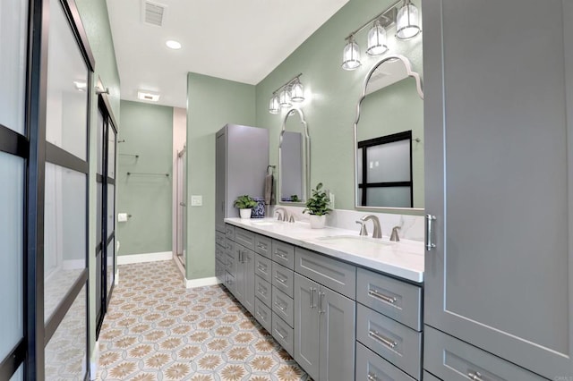4710 Sleeping Indian Rd, Fallbrook, CA 92028 - full bath with baseboards, a sink, visible vents, and double vanity