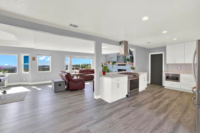 4710 Sleeping Indian Rd, Fallbrook, CA 92028 - kitchen featuring tasteful backsplash, range hood, open floor plan, appliances with stainless steel finishes, and visible vents