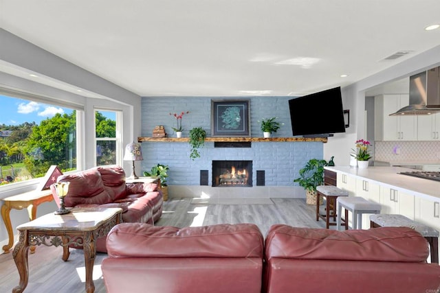 4710 Sleeping Indian Rd, Fallbrook, CA 92028 - living room featuring a fireplace, wood finished floors, visible vents, and recessed lighting