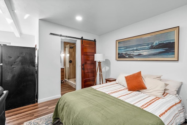 376163 Swift Ave, San Diego, CA 92104 - bedroom with a barn door, wood finished floors, connected bathroom, and baseboards