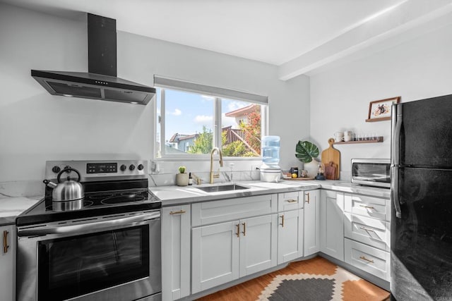 376163 Swift Ave, San Diego, CA 92104 - kitchen with stainless steel appliances, wall chimney range hood, a sink, light wood-style flooring, and light stone countertops