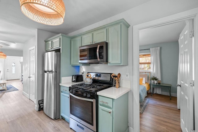 376163 Swift Ave, San Diego, CA 92104 - kitchen featuring stainless steel appliances, green cabinetry, healthy amount of natural light, and light countertops