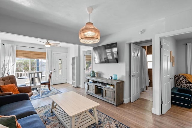 376163 Swift Ave, San Diego, CA 92104 - living room featuring a heating unit, baseboards, light wood-style floors, and ceiling fan