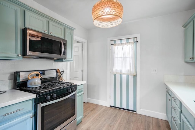 376163 Swift Ave, San Diego, CA 92104 - kitchen featuring appliances with stainless steel finishes, light wood-style flooring, light countertops, and baseboards