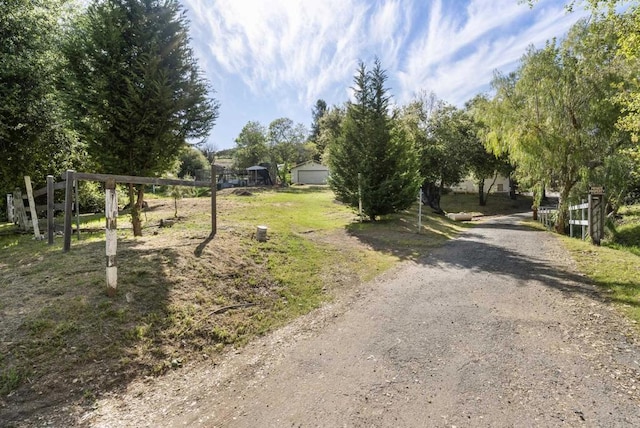 view of road featuring dirt driveway