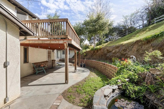 view of yard featuring a deck and a patio