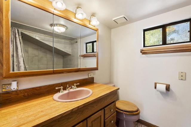 bathroom featuring vanity, a shower with shower curtain, and toilet
