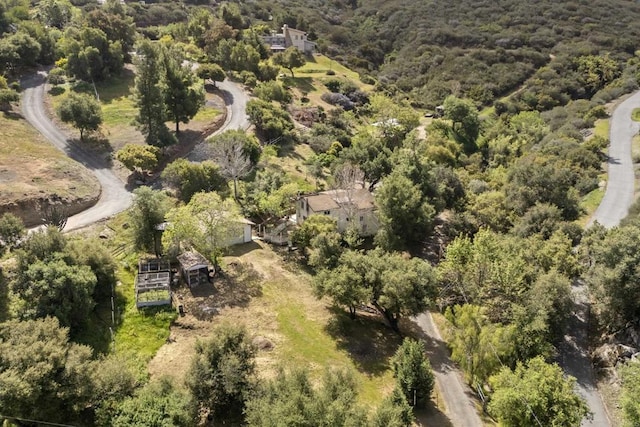 drone / aerial view with a wooded view