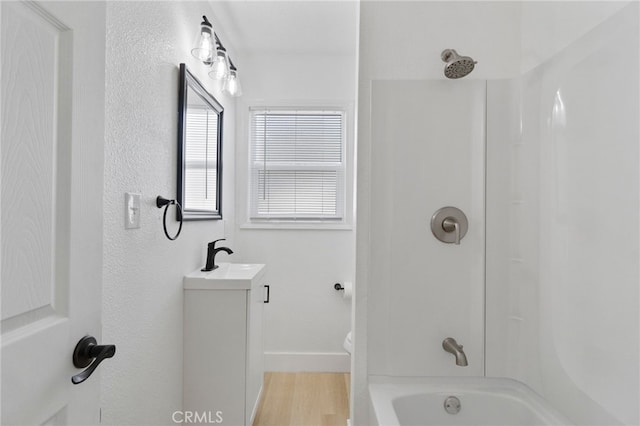 1559 N Carruth Ave, Fresno, CA 93728 - full bathroom featuring vanity, baseboards, bathing tub / shower combination, and wood finished floors