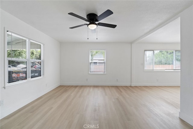 1559 N Carruth Ave, Fresno, CA 93728 - spare room with baseboards, ceiling fan, light wood-type flooring, and a wealth of natural light