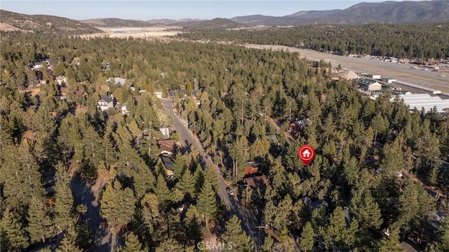 bird's eye view featuring a forest view and a mountain view