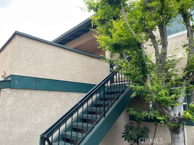view of property exterior featuring stairs and stucco siding