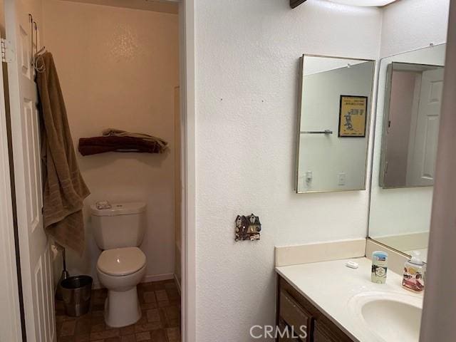 bathroom featuring toilet and vanity