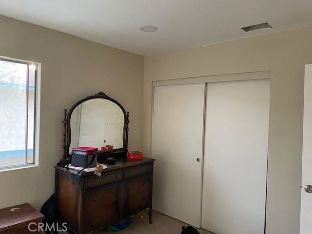 interior space with a closet and visible vents