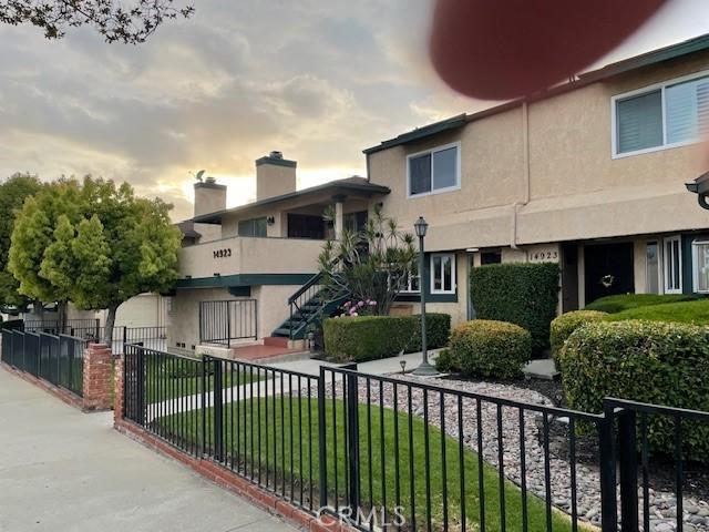 exterior space featuring a yard, fence private yard, and stairway